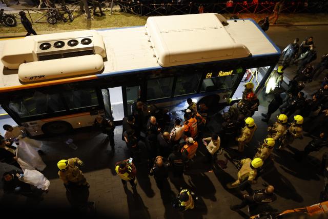 (260106) -- JERUSALEM, Jan. 6, 2026 (Xinhua) -- Israeli police officers inspect a bus involved in the incident in Jerusalem, Jan. 6, 2026. A teenage boy was killed and three others were injured on Tuesday after a bus driver rammed into a protest by ultra-Orthodox Jews in Jerusalem, Israel's emergency services said. (Photo by Jamal Awad/Xinhua)