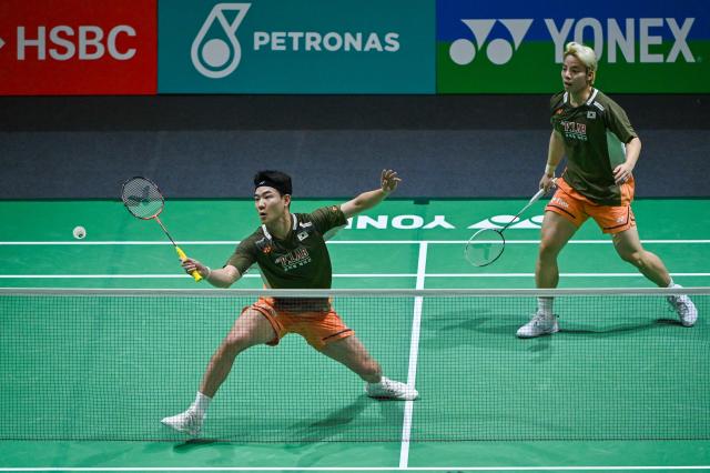 (260107) -- KUALA LUMPUR, Jan. 7, 2026 (Xinhua) -- Kang Min Hyuk (L)/Ki Dong Ju of South Korea compete during the men's doubles round of 32 match against Huang Di/Ren Xiangyu of China at the Malaysia Open 2026 badminton tournament in Kuala Lumpur, Malaysia, Jan. 7, 2026. (Photo by Chong Voon Chung/Xinhua)