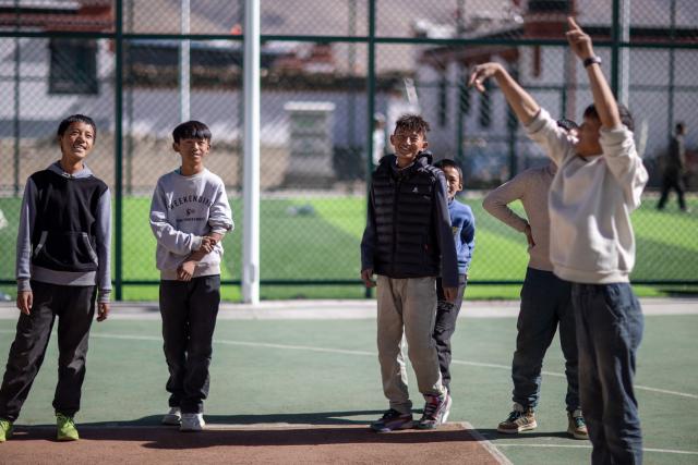 (260107) -- XIGAZE, Jan. 7, 2026 (Xinhua) -- Teenagers play basketball at a basketball court in Zimgag Village of Chamco Township, in Dingri County of Xigaze City, southwest China's Xizang Autonomous Region, on Jan. 5, 2026. In January 2025, a 6.8-magnitude earthquake struck Dingri County in the city of Xigaze, leveling thousands of houses.
  Ten months after the earthquake, more than 32,500 destroyed or damaged houses have been restored and handed over to affected residents. 
   In Zimgag Village, one of the villages hardest hit by the earthquake, new houses are neat and sturdy and supporting facilities are well-equipped. People live a stable and pleasant life here. (Xinhua/Li Jian)