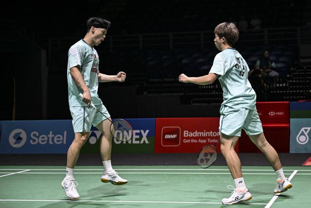 (260107) -- KUALA LUMPUR, Jan. 7, 2026 (Xinhua) -- Chen Xujun (L)/Liu Yang of China react during the men's doubles round of 32 match against Liu Kuang Heng/Yang Po Han of Chinese Taipei at the Malaysia Open 2026 badminton tournament in Kuala Lumpur, Malaysia, Jan. 7, 2026. (Xinhua/Cheng Yiheng)