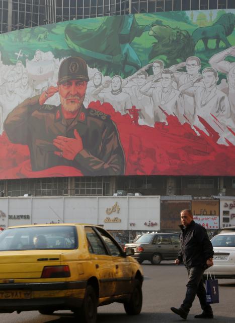 (260107) -- TEHRAN, Jan. 7, 2026 (Xinhua) -- A man walks past a billboard depicting Qassem Soleimani, former commander of the Islamic Revolutionary Guard Corps (IRGC) Quds Force, in downtown Tehran, Iran, Jan. 6, 2026. Iran's army chief warned on Wednesday that the country will respond if hostile rhetoric by its "enemies" continues, according to the official IRNA news agency. (Xinhua)