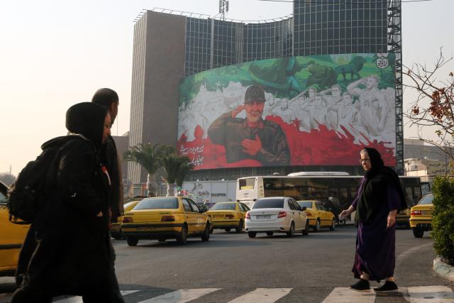 (260107) -- TEHRAN, Jan. 7, 2026 (Xinhua) -- People walk past a billboard depicting Qassem Soleimani, former commander of the Islamic Revolutionary Guard Corps (IRGC) Quds Force, in downtown Tehran, Iran, Jan. 6, 2026. Iran's army chief warned on Wednesday that the country will respond if hostile rhetoric by its "enemies" continues, according to the official IRNA news agency. (Xinhua)