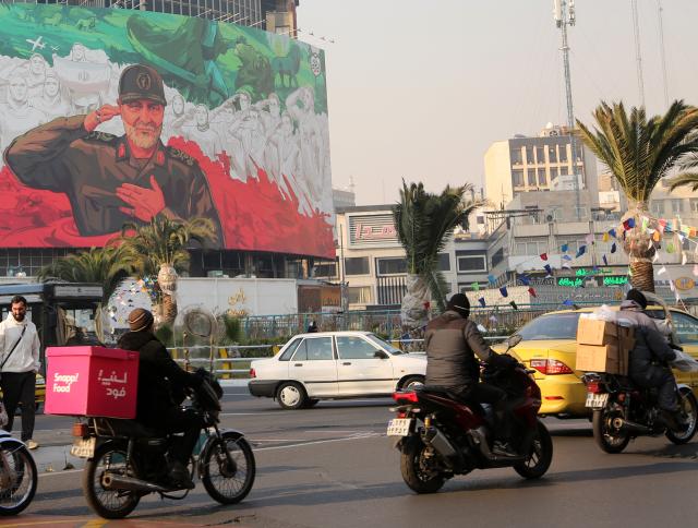 (260107) -- TEHRAN, Jan. 7, 2026 (Xinhua) -- People drive past a billboard depicting Qassem Soleimani, former commander of the Islamic Revolutionary Guard Corps (IRGC) Quds Force, in downtown Tehran, Iran, Jan. 6, 2026. Iran's army chief warned on Wednesday that the country will respond if hostile rhetoric by its "enemies" continues, according to the official IRNA news agency. (Xinhua)