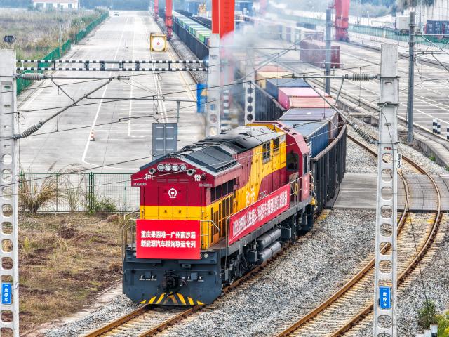 (260108) -- BEIJING, Jan. 8, 2026 (Xinhua) -- An aerial drone photo taken on Jan. 7, 2026 shows a freight train loaded with Chongqing-manufactured new energy vehicles departing from Yuzui Station at Guoyuan Port in Chongqing, southwest China. Departing on Wednesday, this freight train is expected to arrive at Nansha Port in south China's Guangzhou City after 48 hours and then be transferred to a vessel bound for the Middle East. (Xinhua/Tang Yi)