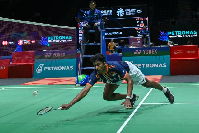 (260108) -- KUALA LUMPUR, Jan. 8, 2026 (Xinhua) - Ayush Shetty of India hits a return during the men's singles round of 16 match against Shi Yuqi of China at the Malaysia Open 2026 badminton tournament in Kuala Lumpur, Malaysia, Jan. 8, 2026. (Photo by Chong Voon Chung/Xinhua)