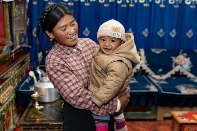 (260108) -- TINGRI, Jan. 8, 2026 (Xinhua) -- Cering Lhaba and his mother are pictured at their newly-decorated home in a village of Chamco Township, Tingri County of Xigaze City, southwest China's Xizang Autonomous Region, on Nov. 11, 2025.
  A 6.8-magnitude earthquake struck Tingri County in the city of Xigaze on Jan. 7, 2025, leveling thousands of houses. The day after the earthquake, Cering Lhaba was born in a hospital in Xigaze.
  After being discharged from the hospital, the boy from quake-affected Tingri became the beloved baby of the residents living in the temporary prefabricated houses. When his parents had no time to take care of him, neighbors, village cadres and local officials all became his temporary babysitters.
  Cering Lhaba, who has just spent his first birthday, has grown up healthily, and lives a pleasant life in his spacious and bright new home. (Xinhua/Jiang Fan)