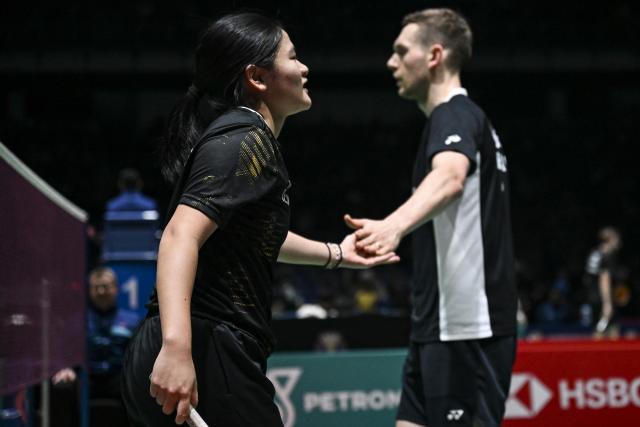 (260108) -- KUALA LUMPUR, Jan. 8, 2026 (Xinhua) -- Marvin Seidel/Thuc Phuong Nguyen (L) of Germany react during the mixed doubles round of 16 match against Guo Xinwa/Chen Fanghui of China at the Malaysia Open 2026 badminton tournament in Kuala Lumpur, Malaysia, Jan. 8, 2026. (Xinhua/Cheng Yiheng)