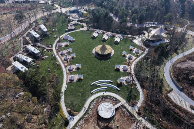 (260108) -- JINHUA, Jan. 8, 2026 (Xinhua) -- An aerial drone photo taken on Jan. 8, 2026 shows a camping base in Jindong District of Jinhua City, east China's Zhejiang Province. In recent years, Jindong District of Jinhua City has developed the cultural and tourism industry by leveraging its cultural, sports and music resources, creating new consumption scenarios for tourism with distinctive features, including sports parks, camping bases, old rural streets and ceramic art galleries. (Xinhua/Xu Yu)