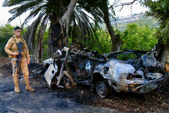 (260108) -- SIDON, Jan. 8, 2026 (Xinhua) -- A soldier from the Lebanese army stands near the wreckage of a car targeted by an Israeli airstrike in the Sidon district, southern Lebanon, Jan. 8, 2026. A Hezbollah member was killed on Thursday afternoon in an Israeli airstrike in the Sidon district in southern Lebanon, Lebanon's official National News Agency (NNA) reported. (Photo by Ali Hashisho/Xinhua)