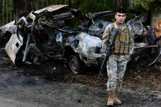 (260108) -- SIDON, Jan. 8, 2026 (Xinhua) -- A soldier from the Lebanese army stands near the wreckage of a car targeted by an Israeli airstrike in the Sidon district, southern Lebanon, Jan. 8, 2026. A Hezbollah member was killed on Thursday afternoon in an Israeli airstrike in the Sidon district in southern Lebanon, Lebanon's official National News Agency (NNA) reported. (Photo by Ali Hashisho/Xinhua)