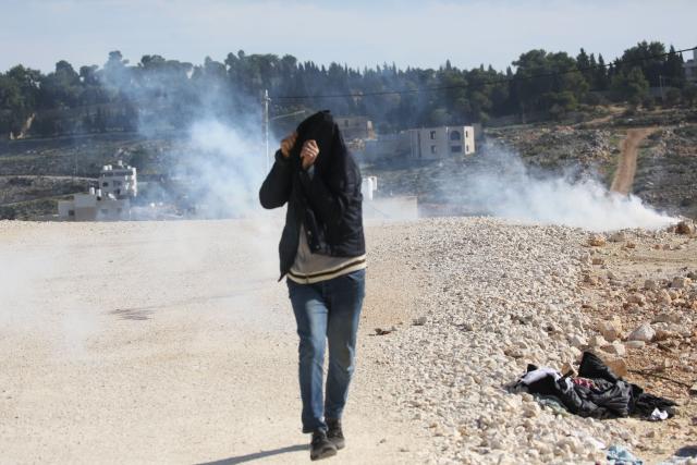 (260109) -- NABLUS, Jan. 9, 2026 (Xinhua) -- A Palestinian takes cover from the tear gas shot by Israeli forces as Israeli excavators demolish a house in the Upper Ta'awun area of Nablus in the West Bank on Jan. 8, 2026. (Photo by Nidal Eshtayeh/Xinhua)