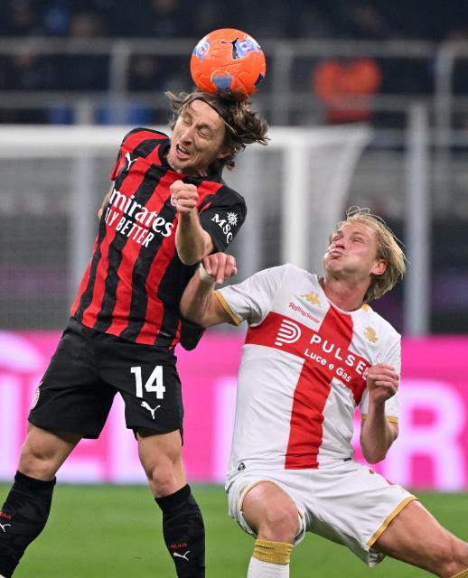 (260109) -- MILAN, Jan. 9, 2026 (Xinhua) -- AC Milan's Luka Modric (L) vies with Genoa's Morten Thorsby during a Serie A football match between AC Milan and Genoa in Milan, Italy, Jan.8, 2026. (Photo by Alberto Lingria/Xinhua)