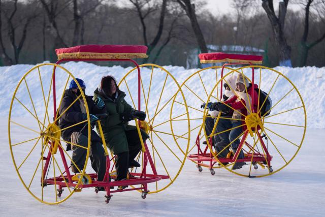 (260109) -- HARBIN, Jan. 9, 2026 (Xinhua) -- Tourists ride on ice while visiting the 38th Sun Island International Snow Sculpture Art Expo in Harbin, northeast China's Heilongjiang Province, Jan. 8, 2026.
  The ongoing snow sculpture art expo, with an exhibition area of 1.5 million square meters, is attracting visitors to its stunning ice and snow landscapes. (Xinhua/Wang Jianwei)