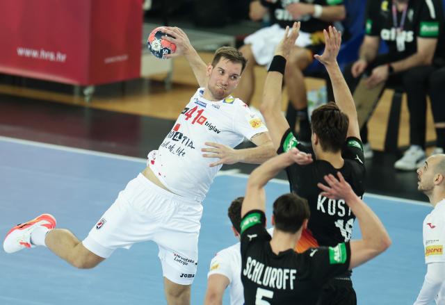 (260109) -- ZAGREB, Jan. 9 (Xinhua) -- Tin Lucin (L) of Croatia shoots the ball during the international handball friendly match between Croatia and Germany in Zagreb, Croatia on Jan. 8, 2026. (Photo by Goran Stanzl/PIXSELL via Xinhua)
