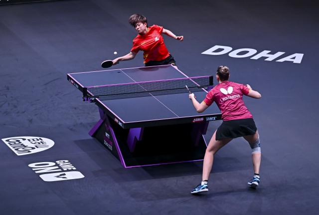 (260109) -- DOHA, Jan. 9, 2026 (Xinhua) -- Wang Yidi (top) of China hits a return during the women's singles round of 16 match against Sofia Polcanova of Austria at the WTT Champions Doha 2026 in Doha, Qatar, Jan. 9, 2026. (Photo by Nikku/Xinhua)