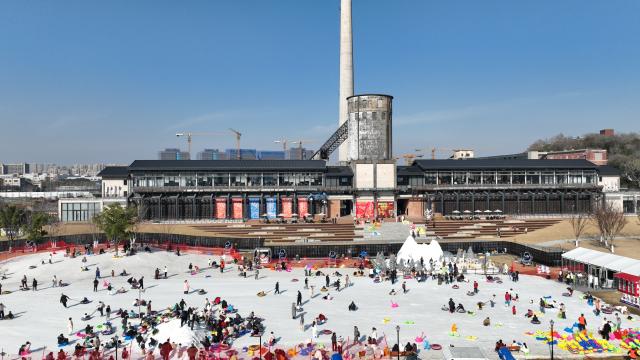 (260109) -- HANGZHOU, Jan. 9, 2026 (Xinhua) -- A drone photo taken on Jan. 9, 2026 shows people enjoying themselves at an ice and snow carnival in Hangzhou, east China's Zhejiang Province. An ice and snow carnival kicked off at the Hangzhou grand canal steelworks park on Friday, attracting visitors across the city.  
  Since 2020, Hangzhou has been undertaking the preservation and transformation of industrial relics from Hangzhou iron and steel group's factory, aiming to create an urban complex park that integrates industrial, commercial, and recreational facilities. Currently, the first phase of the construction project has been put into use, while the second phase is set to be completed and operational by 2028. (Xinhua/Weng Xinyang)