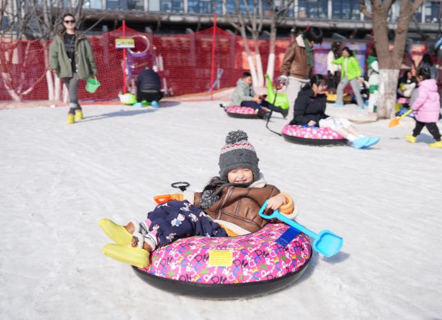 (260109) -- HANGZHOU, Jan. 9, 2026 (Xinhua) -- People enjoy themselves at an ice and snow carnival in Hangzhou, east China's Zhejiang Province, Jan. 9, 2026. An ice and snow carnival kicked off at the Hangzhou grand canal steelworks park on Friday, attracting visitors across the city.  
  Since 2020, Hangzhou has been undertaking the preservation and transformation of industrial relics from Hangzhou iron and steel group's factory, aiming to create an urban complex park that integrates industrial, commercial, and recreational facilities. Currently, the first phase of the construction project has been put into use, while the second phase is set to be completed and operational by 2028. (Xinhua/Weng Xinyang)