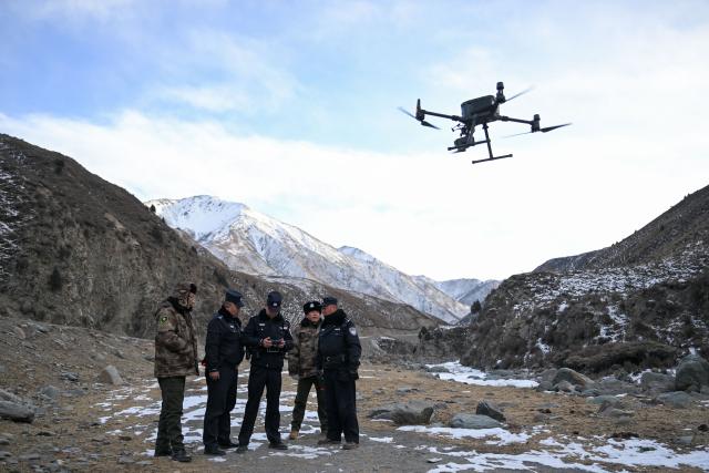(260109) -- MENYUAN, Jan. 9, 2026 (Xinhua) -- Police officers and rangers use a drone to conduct a patrol in the Laohugou region of Menyuan Hui Autonomous County in Haibei Tibetan Autonomous Prefecture, northwest China's Qinghai Province, Jan. 8, 2026. For years, police officers and rangers inside Qilian Mountain National Park in northwest China's Qinghai Province have dedicated themselves to their work, carrying out regular patrols and safeguarding the region's ecological security despite high altitude and harsh winter weather. (Xinhua/Zhang Long)