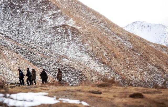 (260109) -- MENYUAN, Jan. 9, 2026 (Xinhua) -- Police officers and rangers patrol the Qilian Mountains in the Laohugou region of Menyuan Hui Autonomous County in Haibei Tibetan Autonomous Prefecture, northwest China's Qinghai Province, Jan. 8, 2026. For years, police officers and rangers inside Qilian Mountain National Park in northwest China's Qinghai Province have dedicated themselves to their work, carrying out regular patrols and safeguarding the region's ecological security despite high altitude and harsh winter weather. (Xinhua/Qi Zhiyue)