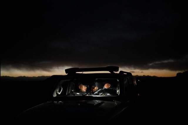 (260109) -- MENYUAN, Jan. 9, 2026 (Xinhua) -- Police officers take a rest during a patrol in the Laohugou region of Menyuan Hui Autonomous County in Haibei Tibetan Autonomous Prefecture, northwest China's Qinghai Province, Jan. 8, 2026. For years, police officers and rangers inside Qilian Mountain National Park in northwest China's Qinghai Province have dedicated themselves to their work, carrying out regular patrols and safeguarding the region's ecological security despite high altitude and harsh winter weather. (Xinhua/Zhang Long)