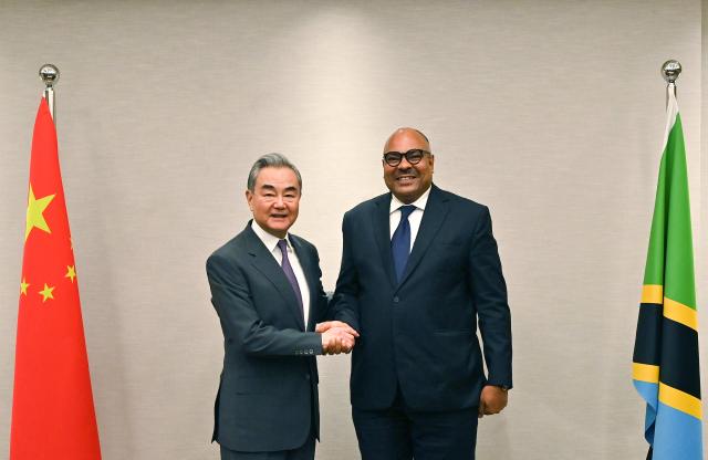 (260109) -- DAR ES SALAAM, Jan. 9, 2026 (Xinhua) -- Chinese Foreign Minister Wang Yi, also a member of the Political Bureau of the Communist Party of China Central Committee, meets with Tanzanian Minister of Foreign Affairs and East African Cooperation Mahmoud Thabit Kombo, in Dar es Salaam, Tanzania, Jan. 9, 2026. (Xinhua/Liu Qiong)