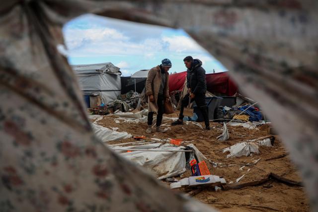 (260109) -- GAZA, Jan. 9, 2026 (Xinhua) -- Palestinians inspect the damage caused by an Israeli strike that targeted a camp housing displaced people in Gaza City, on Jan. 9, 2026. (Photo by Rizek Abdeljawad/Xinhua)
