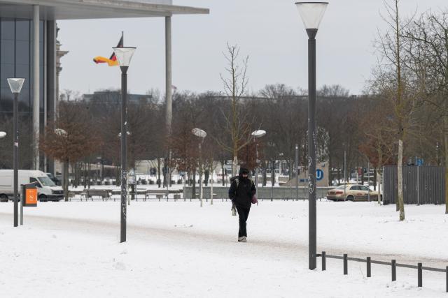 (260109) -- BERLIN, Jan. 9, 2026 (Xinhua) -- A man walks on a snow-covered path in Berlin, capital of Germany, Jan. 9, 2026. Winter Storm Elli swept across large parts of Germany on Friday, killing at least three people and severely disrupting transport, schools and public services, particularly in the country's north. (Xinhua/Zhang Haofu)