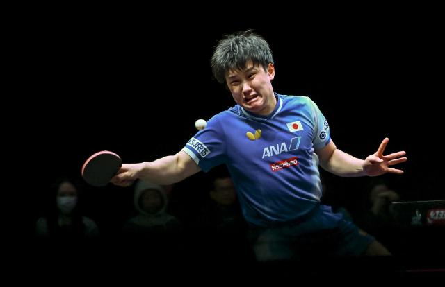(260110) -- DOHA, Jan. 10, 2026 (Xinhua) -- Harimoto Tomokazu of Japan hits a return during the men's singles Round of 16 match against Zhou Qihao of China at the WTT Champions Doha 2026 in Doha, Qatar, Jan. 9, 2026. (Photo by Nikku/Xinhua)