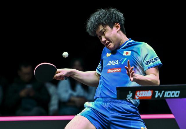 (260110) -- DOHA, Jan. 10, 2026 (Xinhua) -- Harimoto Tomokazu of Japan hits a return during the men's singles Round of 16 match against Zhou Qihao of China at the WTT Champions Doha 2026 in Doha, Qatar, Jan. 9, 2026. (Photo by Nikku/Xinhua)