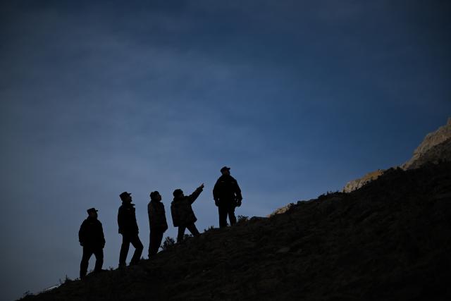 (260110) -- BEIJING, Jan. 10, 2026 (Xinhua) -- Police officers and rangers patrol the Qilian Mountains in the Laohugou region of Menyuan Hui Autonomous County in Haibei Tibetan Autonomous Prefecture, northwest China's Qinghai Province, Jan. 8, 2026. For years, police officers and rangers inside Qilian Mountain National Park in northwest China's Qinghai Province have dedicated themselves to their work, carrying out regular patrols and safeguarding the region's ecological security despite high altitude and harsh winter weather. (Xinhua/Zhang Long)