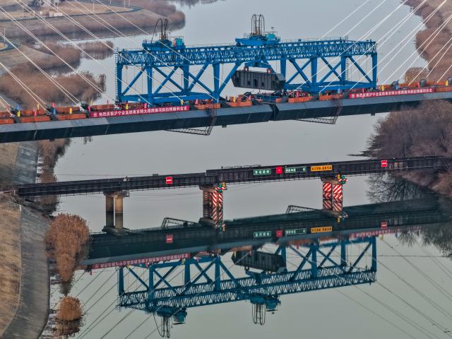 (260110) -- BEIJING, Jan. 10, 2026 (Xinhua) -- An aerial drone photo taken on Jan. 8, 2026 shows the construction site of the cable-stayed bridge across the Chuhe River in Nanjing, east China's Jiangsu Province. As part of a high-speed railway linking Shanghai, Nanjing of Jiangsu Province and Hefei of Anhui Province, the cable-stayed bridge across the Chuhe River completed its closure on Thursday. (Xinhua/Li Bo)