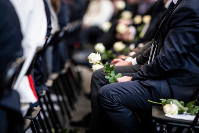 (260110) --  MARTIGNY, Jan. 10, 2026 (Xinhua) -- People with white roses in hand attend the official memorial ceremony mourning the victims of a New Year's Eve bar fire in Martigny, Switzerland, Jan. 9, 2026. Switzerland held a national memorial service on Friday to mourn the victims of a deadly New Year's Eve bar fire in the resort town of Crans-Montana, as authorities continued their investigation into the incident.
   Due to forecasts of heavy snowfall in Crans-Montana, Swiss authorities decided to hold the official ceremony in Martigny, more than 50 kilometers west of the resort town, citing safety concerns. (Photo by Louis Dasselborne/Xinhua)