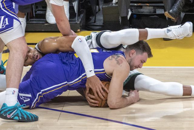 (260110) -- LOS ANGELES, Jan. 10, 2026 (Xinhua) -- Milwaukee Bucks' Giannis Antetokounmpo and Los Angeles Lakers' Luka Doncic (front) vie for the ball during the 2025-2026 NBA regular season game between Los Angeles Lakers and Milwaukee Bucks in Los Angeles, the United States, Jan. 9, 2026. (Photo by Ringo Chiu/Xinhua)