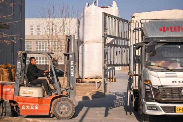 (260110) -- MOYU, Jan. 10, 2026 (Xinhua) -- A staff member prepares to load red jujubes onto a truck heading for north China's Hebei Province at a food company in Moyu County, Hotan Prefecture, northwest China's Xinjiang Uygur Autonomous Region, Jan. 9, 2026. Premium Xinjiang goods like walnuts and red jujubes, which are popular choices for customers nationwide for the Chinese New Year, have entered their peak sales season as the Spring Festival approaches. E-commerce companies in Hotan are leveraging live-streaming sales and online shopping festivals to promote high-quality agricultural products of Xinjiang, boosting farmers' incomes and rural revitalization. (Xinhua/Ding Lei)