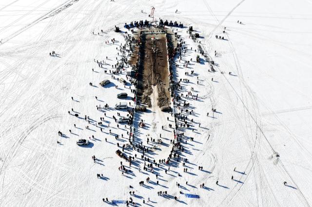 (260110) -- HOHHOT, Jan. 10, 2026 (Xinhua) -- An aerial drone photo shows people attending the 4th Hasuhai Lake winter fishing festival in Tumd Left Banner of Hohhot, north China's Inner Mongolia Autonomous Region, Jan. 10, 2026. The 4th Hasuhai Lake winter fishing festival opened in Tumd Left Banner of Hohhot on Saturday. The activity features ice and snow entertainment, hot spring experience, delicious food and folk shows, attracting many citizens and tourists. (Xinhua/Lian Zhen)
