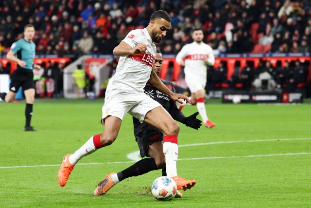 (260111) -- LEVERKUSEN, Jan. 11, 2026 (Xinhua) -- Jeanuel Belocian (rear) of Bayer 04 Leverkusen vies with Josha Vagnoman of VfB Stuttgart during the German first division of Bundesliga football match between Bayer 04 Leverkusen and VfB Stuttgart in Leverkusen, Germany, Jan. 10, 2026. (Photo by Joachim Bywaletz/Xinhua)