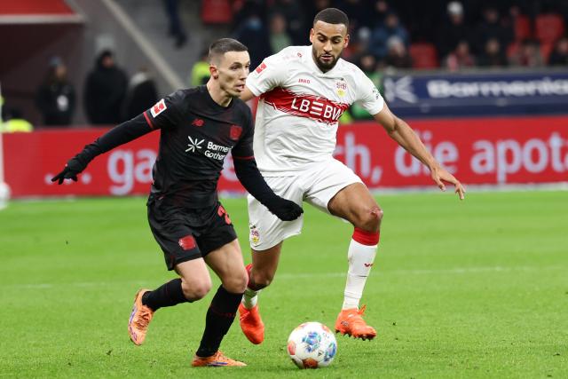 (260111) -- LEVERKUSEN, Jan. 11, 2026 (Xinhua) -- Alejandro Grimaldo (L) of Bayer 04 Leverkusen vies with Josha Vagnoman of VfB Stuttgart during the German first division of Bundesliga football match between Bayer 04 Leverkusen and VfB Stuttgart in Leverkusen, Germany, Jan. 10, 2026. (Photo by Joachim Bywaletz/Xinhua)