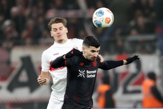 (260111) -- LEVERKUSEN, Jan. 11, 2026 (Xinhua) -- Martin Terrier (R) of Bayer 04 Leverkusen and Ramon Hendriks of VfB Stuttgart head for the ball during the German first division of Bundesliga football match between Bayer 04 Leverkusen and VfB Stuttgart in Leverkusen, Germany, Jan. 10, 2026. (Photo by Joachim Bywaletz/Xinhua)