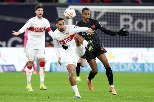 (260111) -- LEVERKUSEN, Jan. 11, 2026 (Xinhua) -- Jeanuel Belocian (R) of Bayer 04 Leverkusen vies with Nikolas Nartey of VfB Stuttgart during the German first division of Bundesliga football match between Bayer 04 Leverkusen and VfB Stuttgart in Leverkusen, Germany, Jan. 10, 2026. (Photo by Joachim Bywaletz/Xinhua)