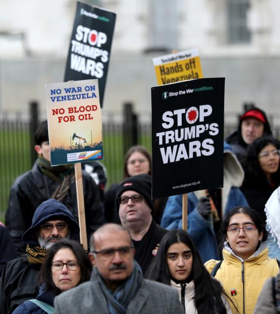 (260111) -- LONDON, Jan. 11, 2026 (Xinhua) -- Demonstrators hold placards during a protest condemning U.S. attack on Venezuela outside No. 10 Downing Street in London, Britain, Jan. 10, 2026. (Xinhua/Li Ying)