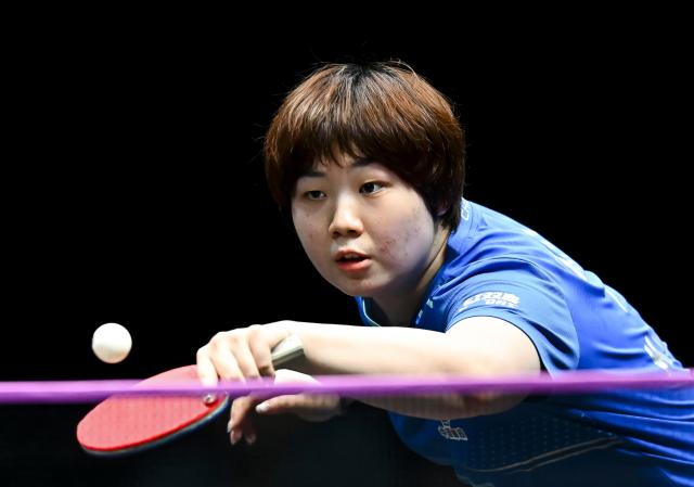 (260111) -- DOHA, Jan. 11, 2026 (Xinhua) -- Kuai Man of China hits a return during the women's singles quarter-final match against Nagasaki Miyu of Japan at the WTT Champions Doha 2026 in Doha, Qatar, on Jan. 10, 2026. (Photo by Nikku/Xinhua)