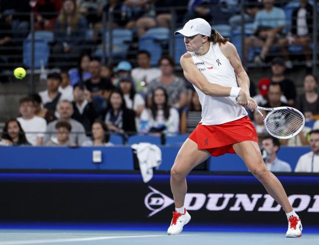 (260111) -- SYDNEY, Jan. 11, 2026 (Xinhua) -- Iga Swiatek of Team Poland hits a return during the women's singles match against Belinda Bencic of Team Switzerland at the 2026 United Cup tennis tournament final in Sydney, Australia, Jan. 11, 2026. (Xinhua/Ma Ping)