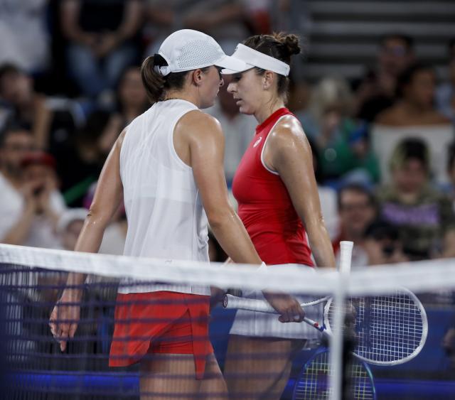 (260111) -- SYDNEY, Jan. 11, 2026 (Xinhua) -- Iga Swiatek (L) of Team Poland and Belinda Bencic of Team Switzerland react during their women's singles match at the 2026 United Cup tennis tournament final in Sydney, Australia, Jan. 11, 2026. (Xinhua/Ma Ping)