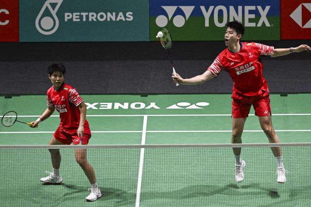 (260111) -- KUALA LUMPUR, Jan. 11, 2026 (Xinhua) -- Feng Yanzhe (R)/Huang Dongping of China compete during the mixed doubles final match against Jiang Zhenbang/Wei Yaxin of China at the Malaysia Open 2026 badminton tournament in Kuala Lumpur, Malaysia, Jan. 11, 2026. (Xinhua/Cheng Yiheng)