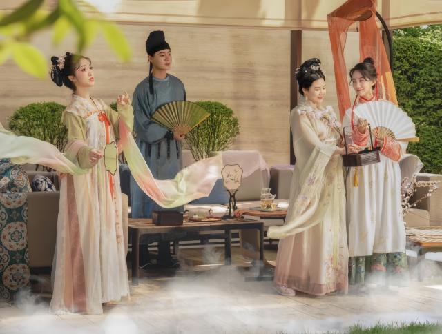 (260111) -- XI'AN, Jan. 11, 2026 (Xinhua) -- Li Huan (2nd R) and members of her team hold a spring-themed tea tasting event at a hotel in Xi'an, northwest China's Shaanxi Province, March 24, 2023. Tangguozi, a sort of desserts inspired by the culture from the Tang Dynasty (618-907), features exquisite designs and vibrant colors, often served with tea. They are now going through a modern revival.
   Bearing years of experience in baking, Li Huan accidentally learned about Tangguozi and co-founded a company specialized in this business in 2020. Li believes that traditional culture is an inexhaustible source of creativity. She and her team often visit museums, drawing inspiration from the patterns and designs of artifacts from the Tang Dynasty. They carefully adjust the recipes by combining healthy diets with modern taste, which made their Tangguozi products increasingly popular.
    Li and her team have expanded their business approach by introducing Tangguozi and tea culture of the Tang Dynasty to domestic and international cultural exchange events, and hosting hands-on workshops for tourists and study groups. They also offer comprehensive services such as event planning and crafts training to make Tangguozi and the Tang culture more tangible and accessible to ordinary people. (Xinhua)