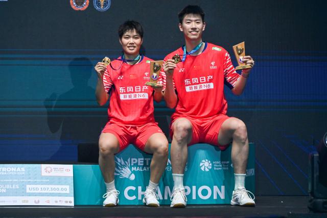 (260111) -- KUALA LUMPUR, Jan. 11, 2026 (Xinhua) -- Feng Yanzhe (R)/Huang Dongping of China pose during the awarding ceremony after the mixed doubles final match against Jiang Zhenbang/Wei Yaxin of China at the Malaysia Open 2026 badminton tournament in Kuala Lumpur, Malaysia, Jan. 11, 2026. (Photo by Chong Voon Chung/Xinhua)