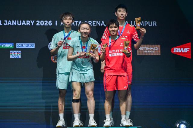 (260111) -- KUALA LUMPUR, Jan. 11, 2026 (Xinhua) -- Feng Yanzhe (R back)/Huang Dongping (R front) and Jiang Zhenbang (L back)/Wei Yaxin of China pose for photo after their mixed doubles final match at the Malaysia Open 2026 badminton tournament in Kuala Lumpur, Malaysia, Jan. 11, 2026. (Photo by Chong Voon Chung/Xinhua)