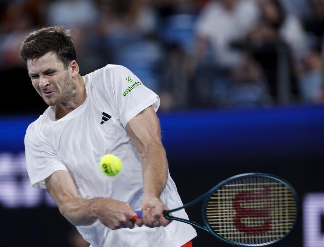 (260111) -- SYDNEY, Jan. 11, 2026 (Xinhua) -- Hubert Hurkacz of Team Poland hits a return during the men's singles match against Stan Wawrinka of Team Switzerland at the 2026 United Cup tennis tournament final in Sydney, Australia, Jan. 11, 2026. (Xinhua/Ma Ping)