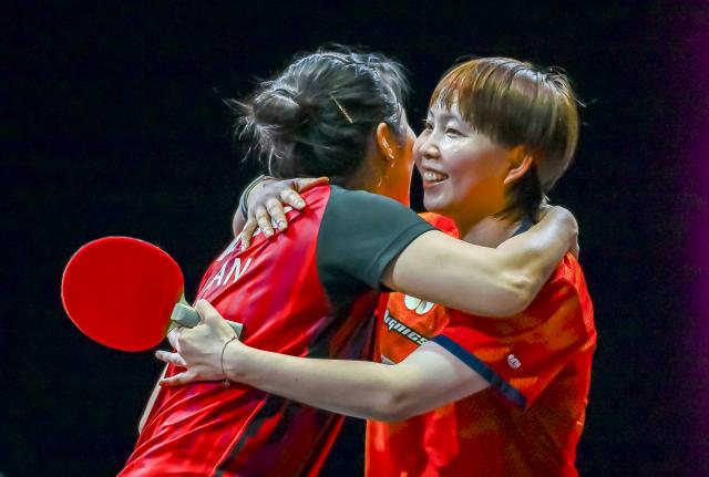 (260111) -- DOHA, Jan. 11, 2026 (Xinhua) -- Zhu Yuling (R) of China's Macao hugs Han Ying of Germany after the women's singles semifinal match at the WTT Champions Doha 2026 in Doha, Qatar, Jan. 11, 2026. (Photo by Nikku/Xinhua)