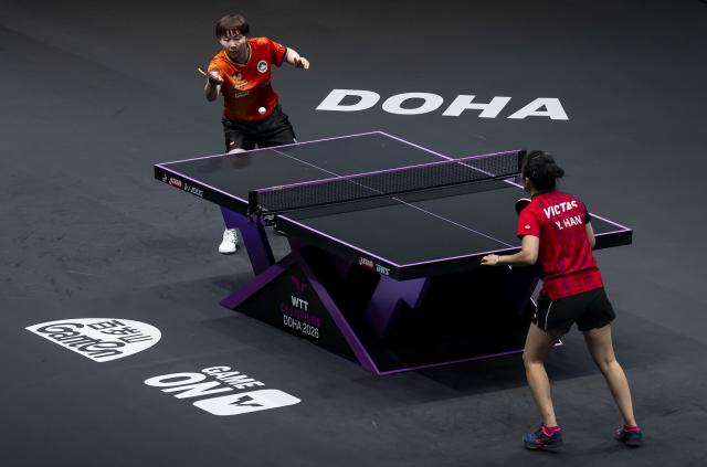 (260111) -- DOHA, Jan. 11, 2026 (Xinhua) -- Zhu Yuling (L) of China's Macao hits a return during the women's singles semifinal match against Han Ying of Germany at the WTT Champions Doha 2026 in Doha, Qatar, Jan. 11, 2026. (Photo by Nikku/Xinhua)